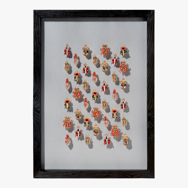 framed wall artwork with metallic beetles embroidered on net fabric