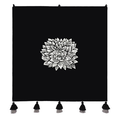 minimalistic monochrome art in black featuring a tapestry with a white embroidered dahlia flower at the center, having five black and grey tiered tassels at the bottom