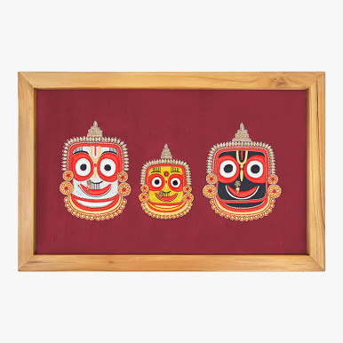 Product feature image showcasing a textile artwork featuring the holy trio of Puri Jagannath Mandir embroidered over maroon silk, framed in wood