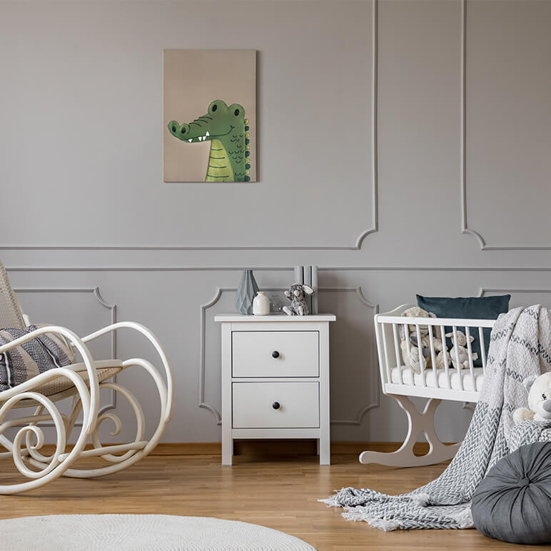 staged view of a nursery room with an alligator artwork displayed on the wall