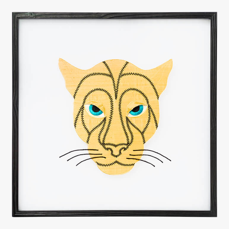 framed animal wall art featuring a golden panther head with blue eyes and black detailing