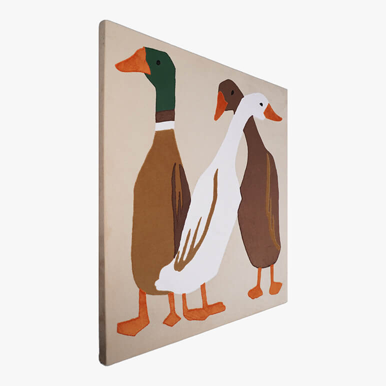 Left angle view of a canvas framed animal themed nursery decor piece, featuring three ducks in earthy colors