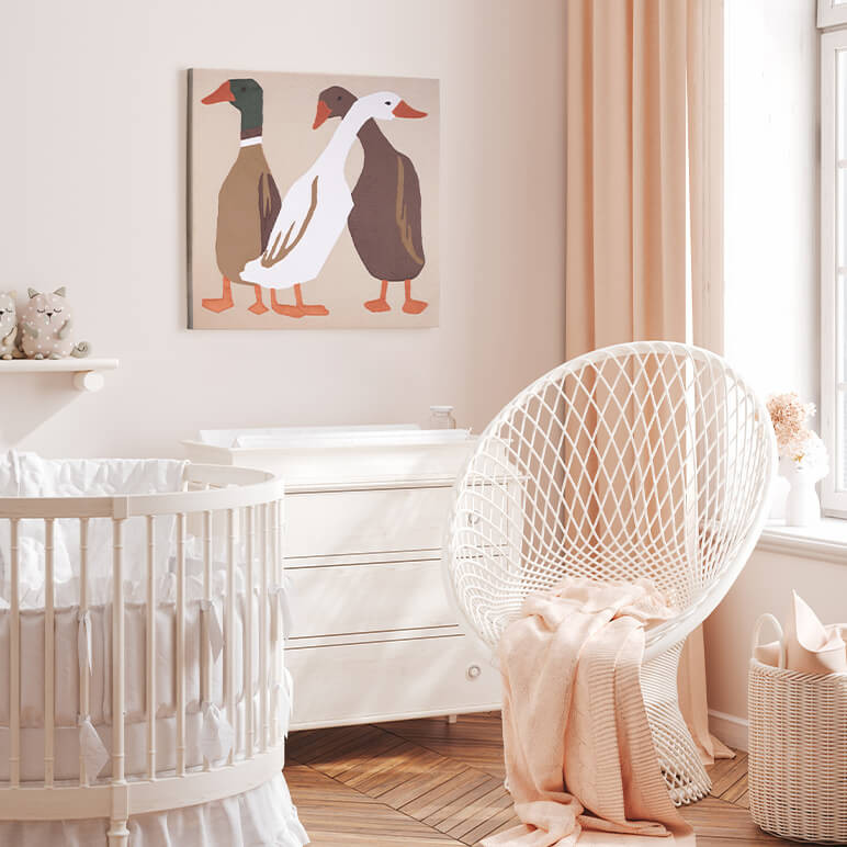 Animal themed nursery decor featuring three earthy color toned ducks, seen displayed in a light pink nursery