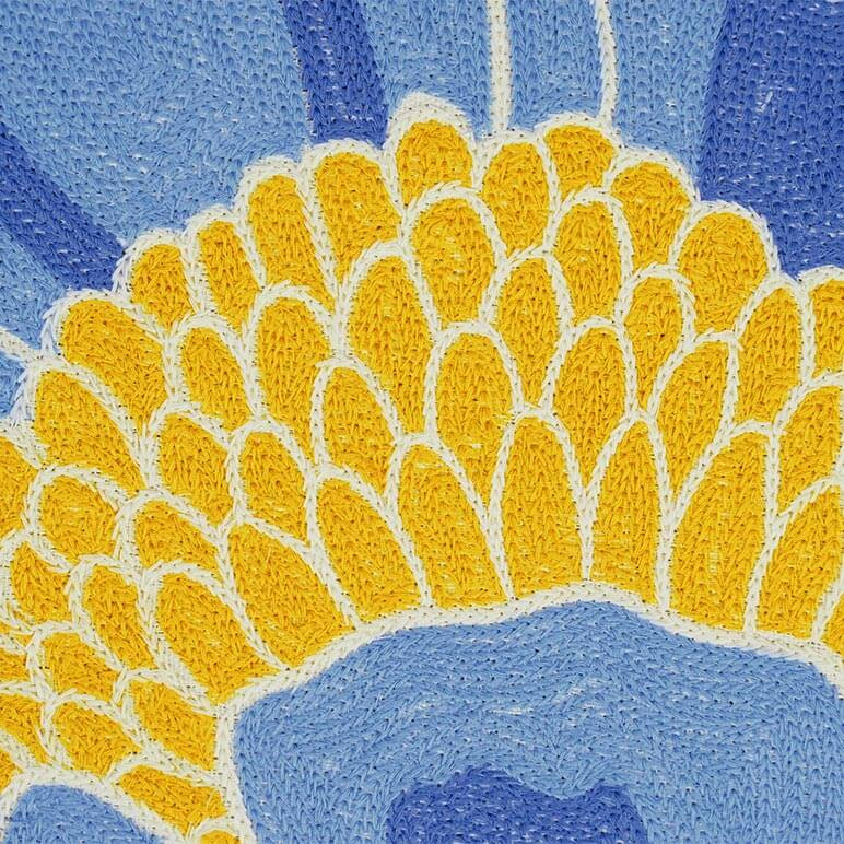 Detailed view of the chainstitch embroidery in blue and yellow on an artwork with flowers