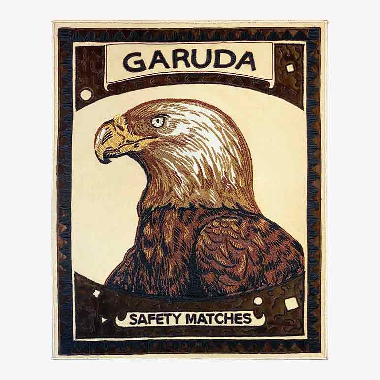 bald eagle artwork on an enlarged matchbox like textile sculpture in earthy and metallic color tones done using french purl wire
