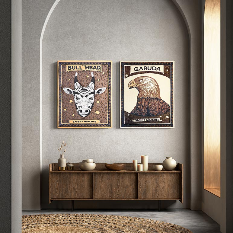 gallery wall with a pair of vintage matchbox inspired textile sculptures named bull head matchbox and garuda matchbox, seen displayed in a grey foyer
