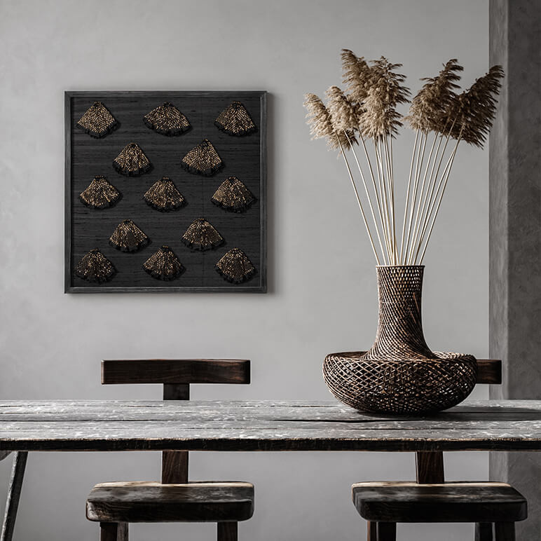 framed black and gold beaded wall art seen in a modern grey dining room