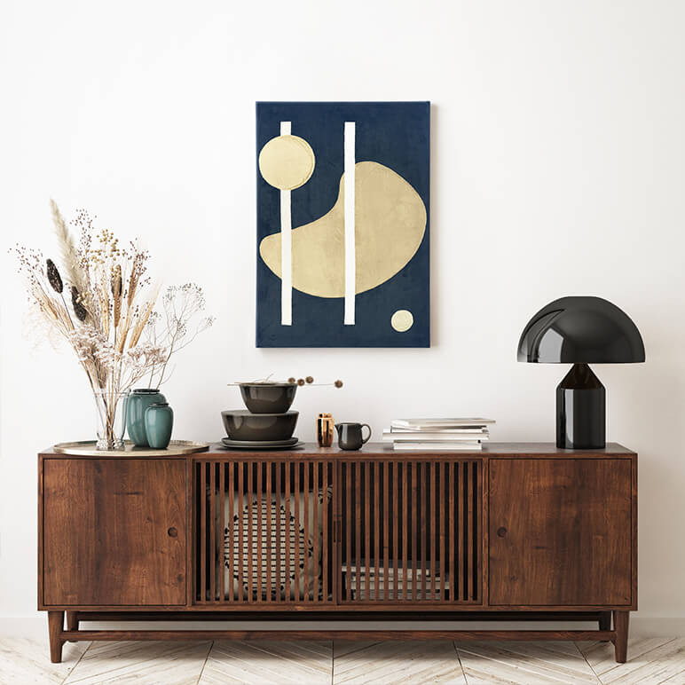 framed black abstract art with organic shapes seen in a modern living room with a wooden console table