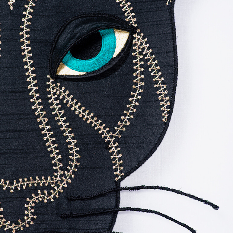 close-up view of the embroidery on a black panther artwork done in fabric and thread