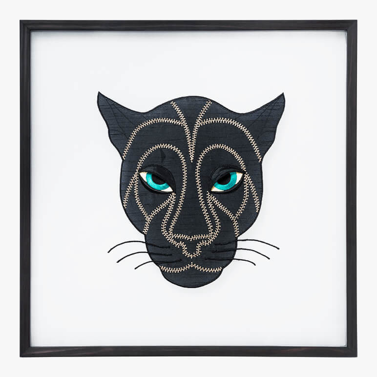 framed black panther with blue eyes art embroidered in fabric and thread
