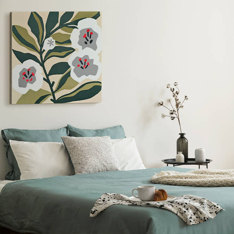 Staged image of a textile at showcasing flower artwork seen displayed in a modern bedroom