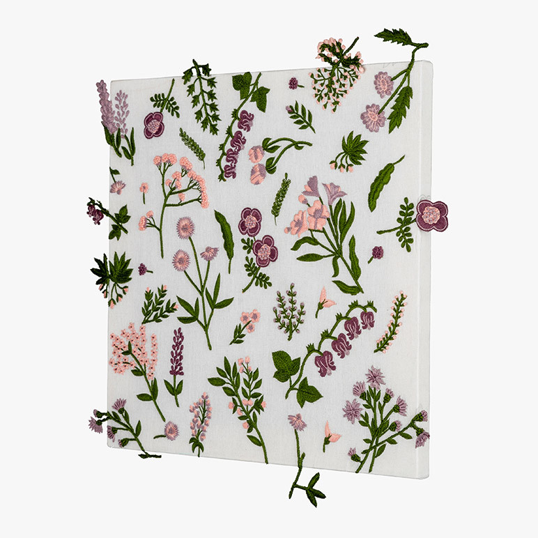 side view of a pastel floral botanical artwork on a white cotton background