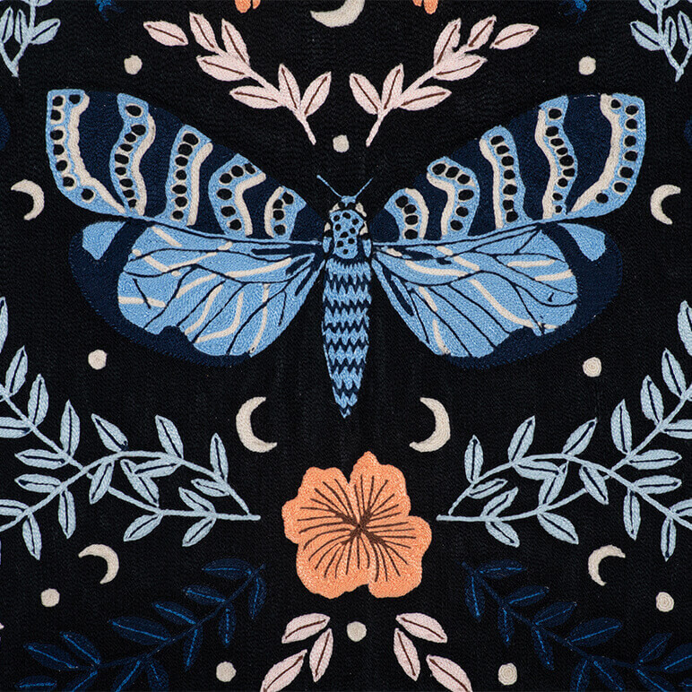 close-up embroidery view of a chainstitched tapestry with butterflies and leaves on a black background