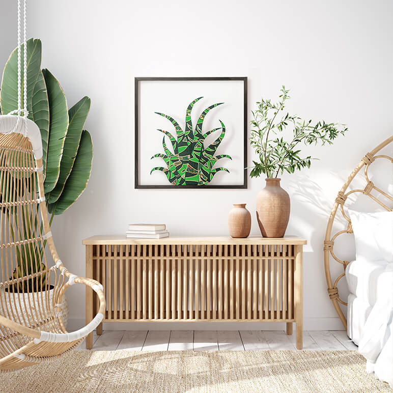 cactus framed textile wall art seen displayed in a white bedroom