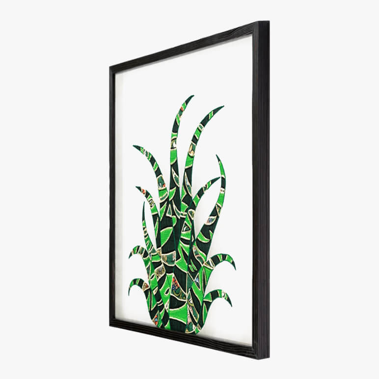 side view of a framed cactus wall art in green color displayed in a black frame