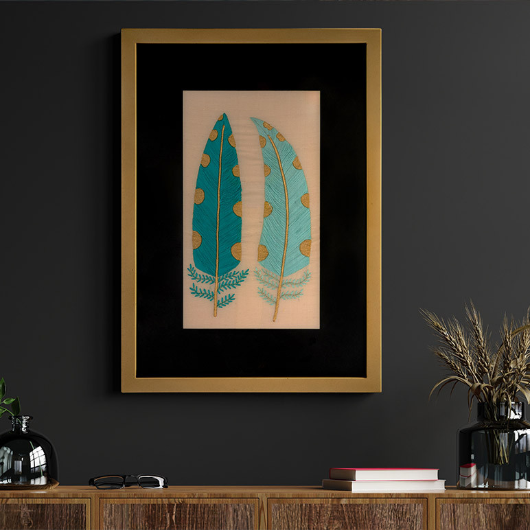 cottagecore room décor piece in the form of a framed textile artwork with two embroidered feathers