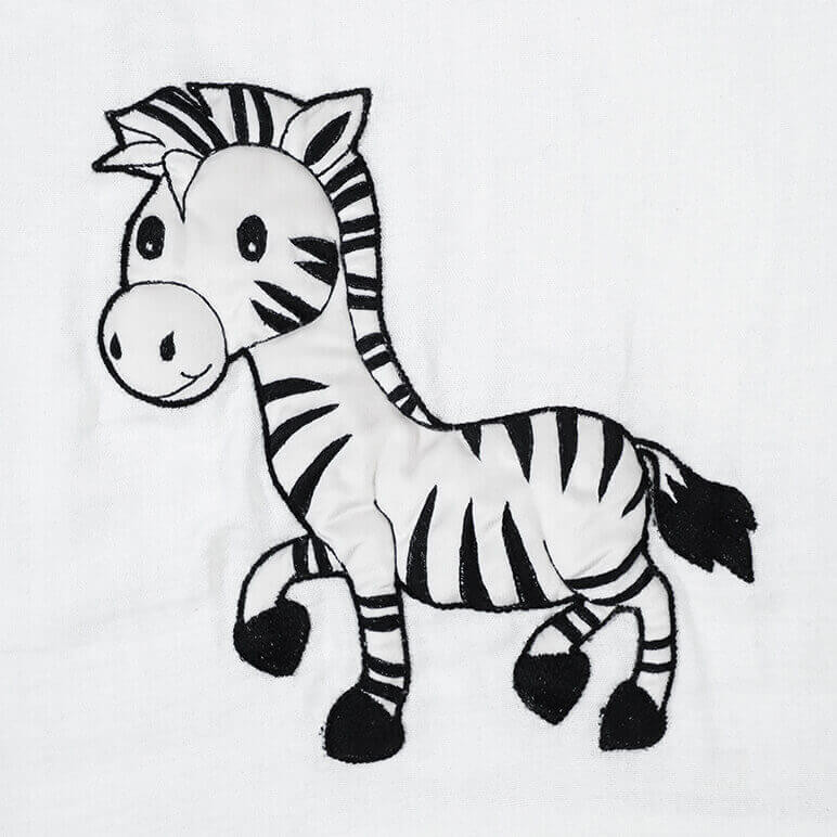 closeup view of an embroidered zebra in black and white standing up