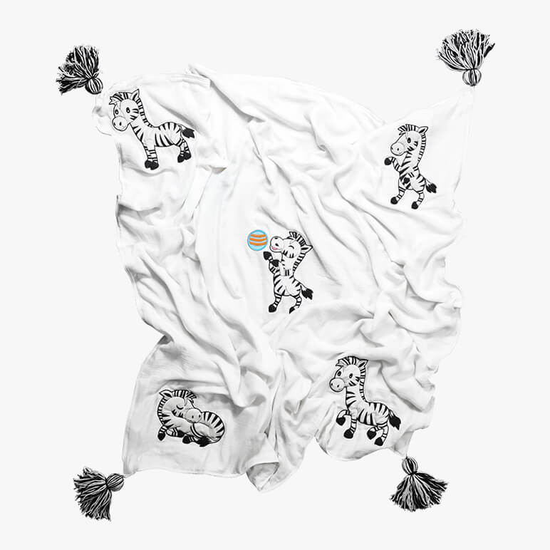 cute zebra blanket for kids in white and black color with five zebras in different poses and 4 wool tassels in black and white