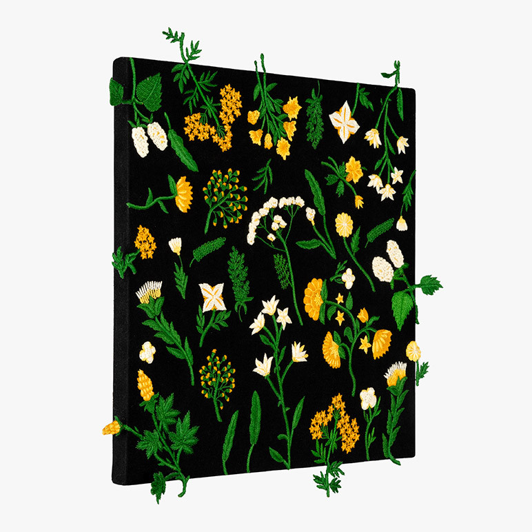 canvas framed black floral wall art with botanical stumpwork in green, yellow and white