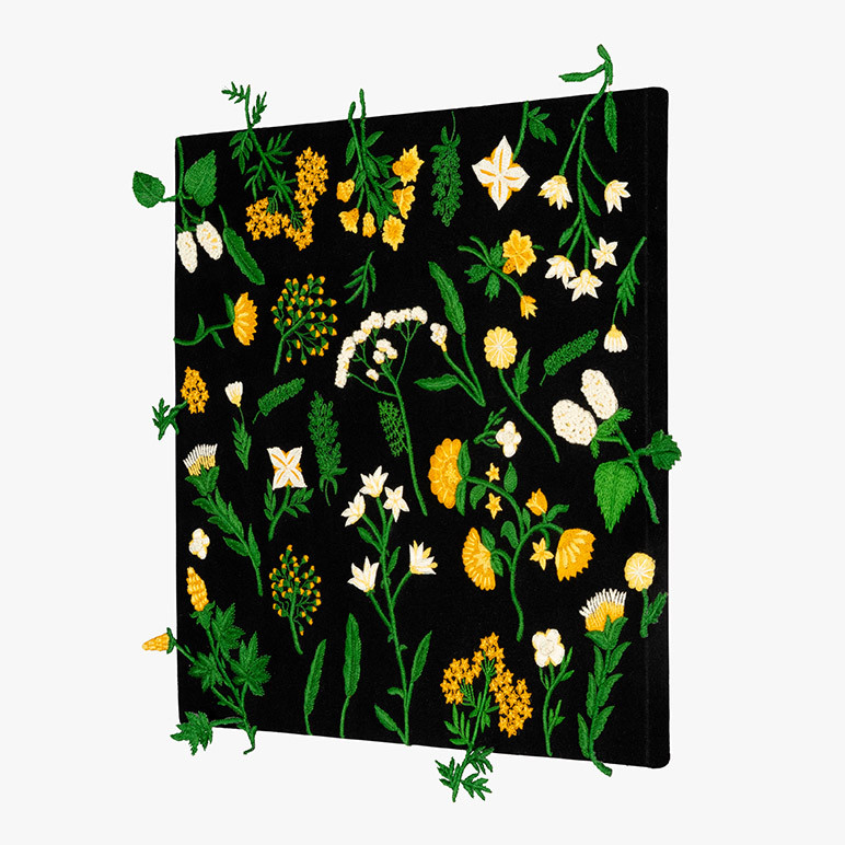side view of canvas framed botanical wall art with floral elements in green, yellow and white