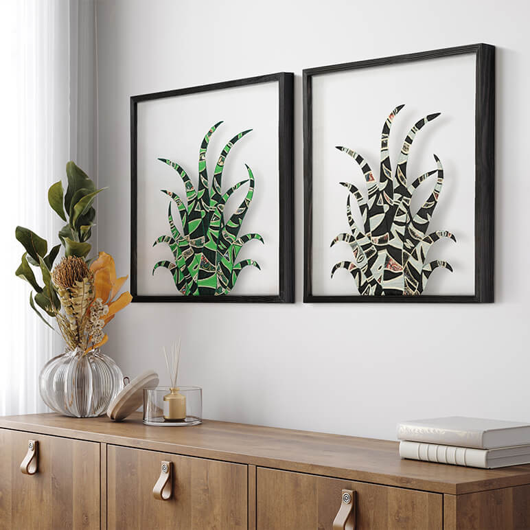 desert themed art pieces framed in a two piece gallery wall in a white living room corner