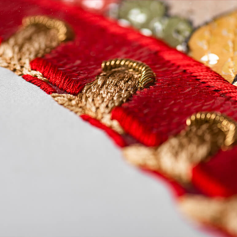 closeup view of the embroidery featuring the lace on a shoe shaped eccentric wall art