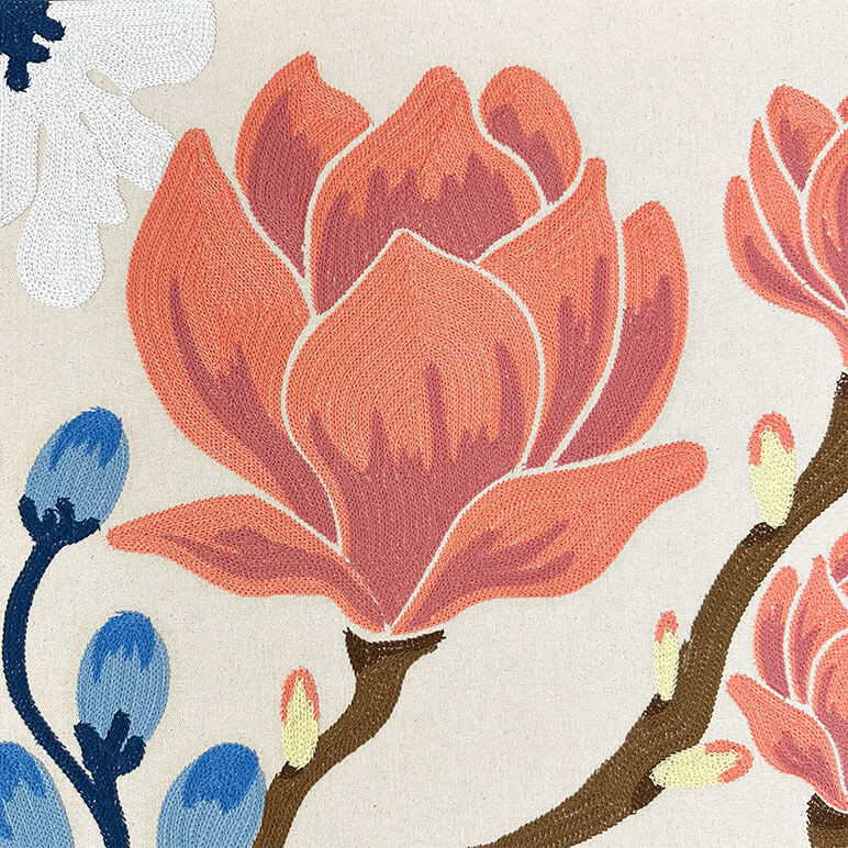 Detailed close up view of the chainstitch embroidery on a floral embroidery design with Magnolias