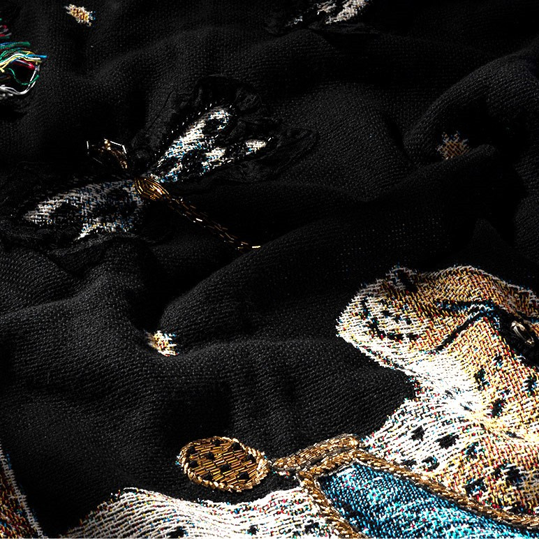 closeup view of the woven wall hanging in black with a golden cheetah over it