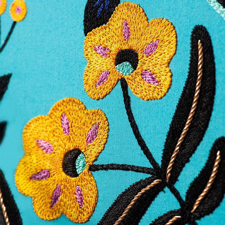 embroidery detail of yellow and black flowers