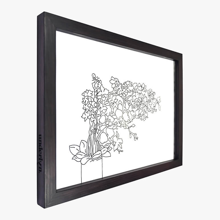 Left side view of a floral line art piece featuring a minimalistic black and white floral art, framed in black