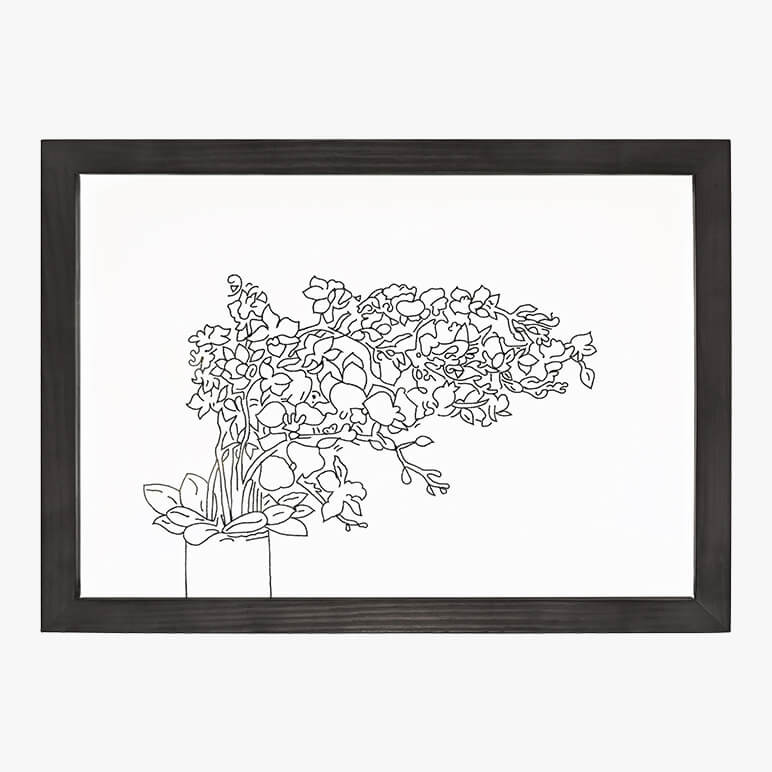 Product feature image of a floral line art piece, in monochrome black and white colors, framed in black