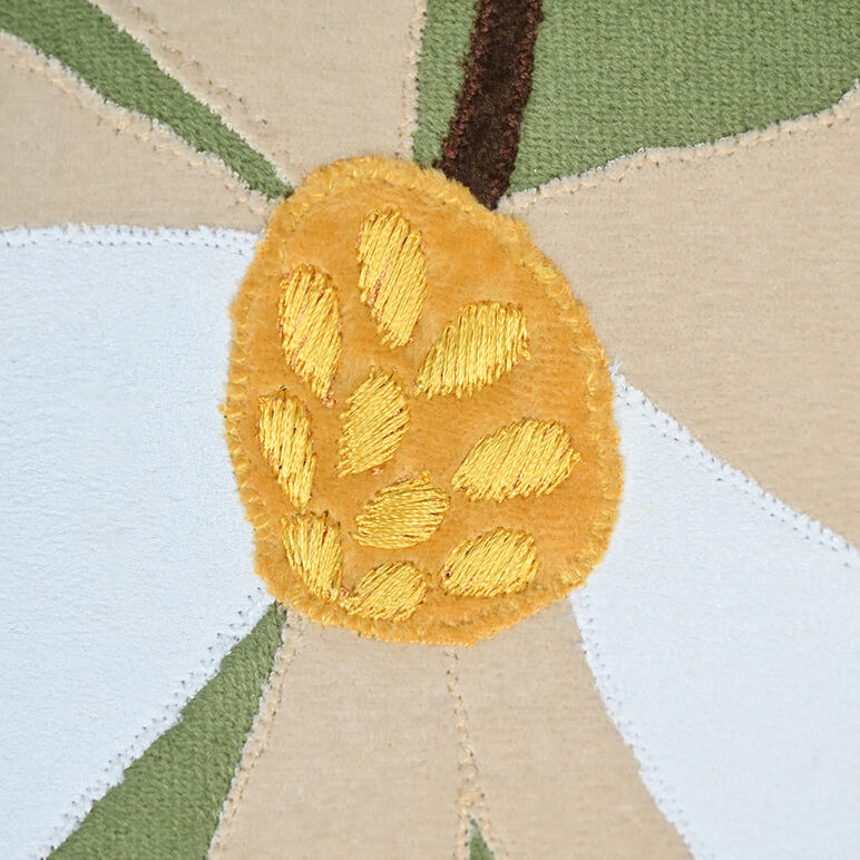 Embroidery detail showing patchwork and threadwork on a floral wall art