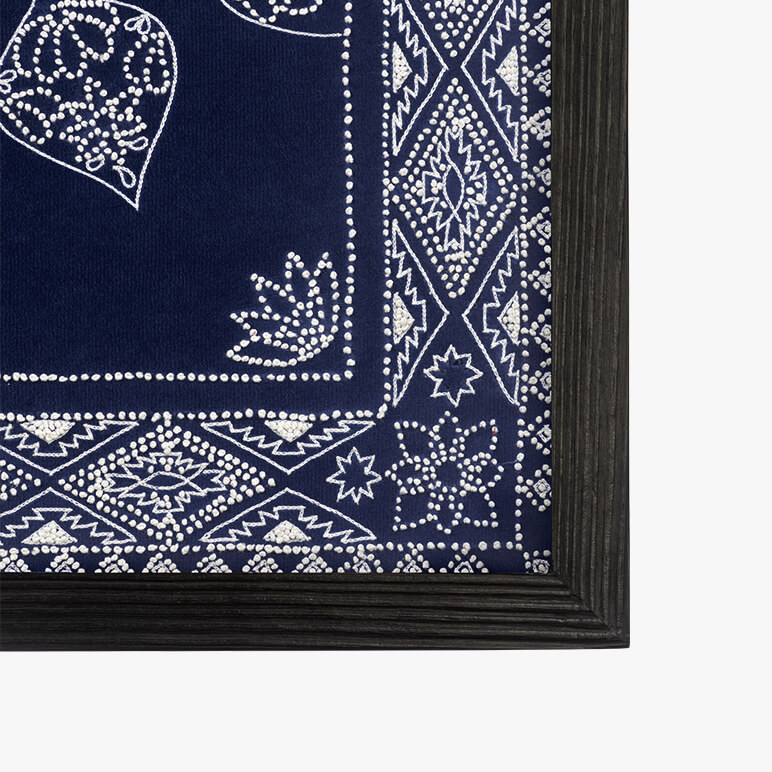 corner detail of a framed larbe blue tapestry
