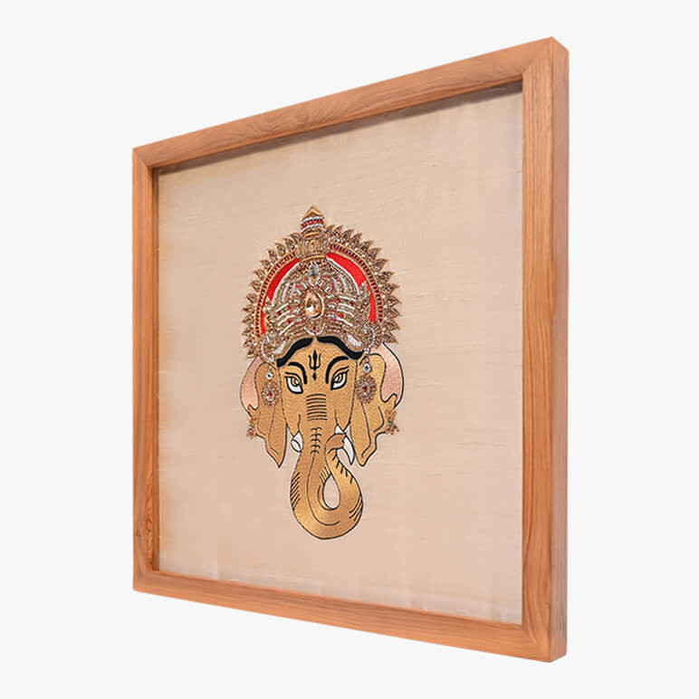 Right angled view of a textile artwork featuring Shri Ganesh, framed in wood