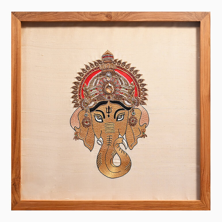 Product feature image of a textile art showcasing Lord Ganesha, hand embroidered and framed in wood
