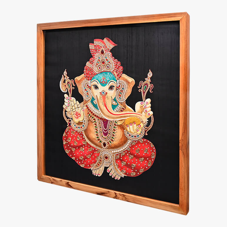 Right angled view of a Ganesha painting done over a black raw silk background, framed in wood