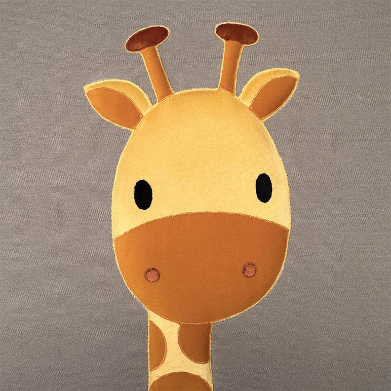 closeup view of a giraffe nursery wall art with a yellow and orange colored cute giraffe head