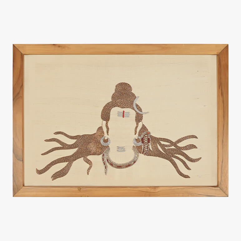 Image featuring a textile artwork showcasing God Shiva art, done using French purl wire in copper shades over a cream fabric background, seen framed in a wooden frame