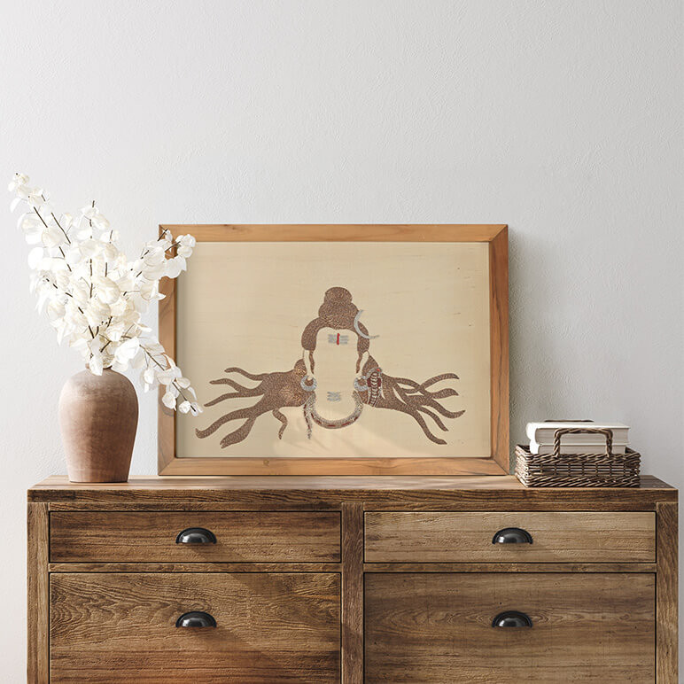 Mood shot of a framed God Shiva textile artwork seen placed above a wooden console table