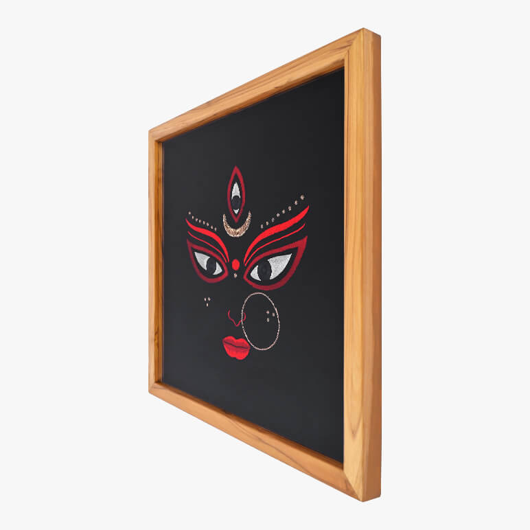 Right angled view of a Goddess Durga textile artwork, framed in wood