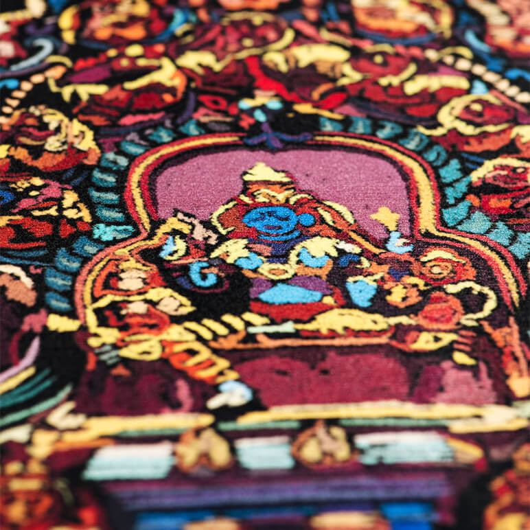 closeup view of a printed velvet textile art showing vivid colors of the sculpture on an Indian temple