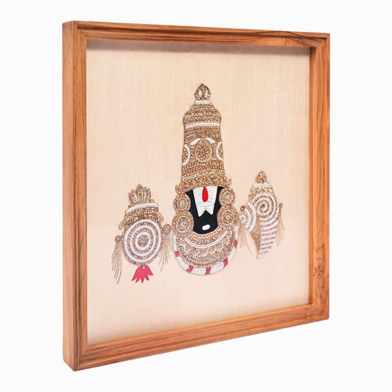 Left angled view of a Lord Venkateswara textile artwork, framed in wood and hand embroidered