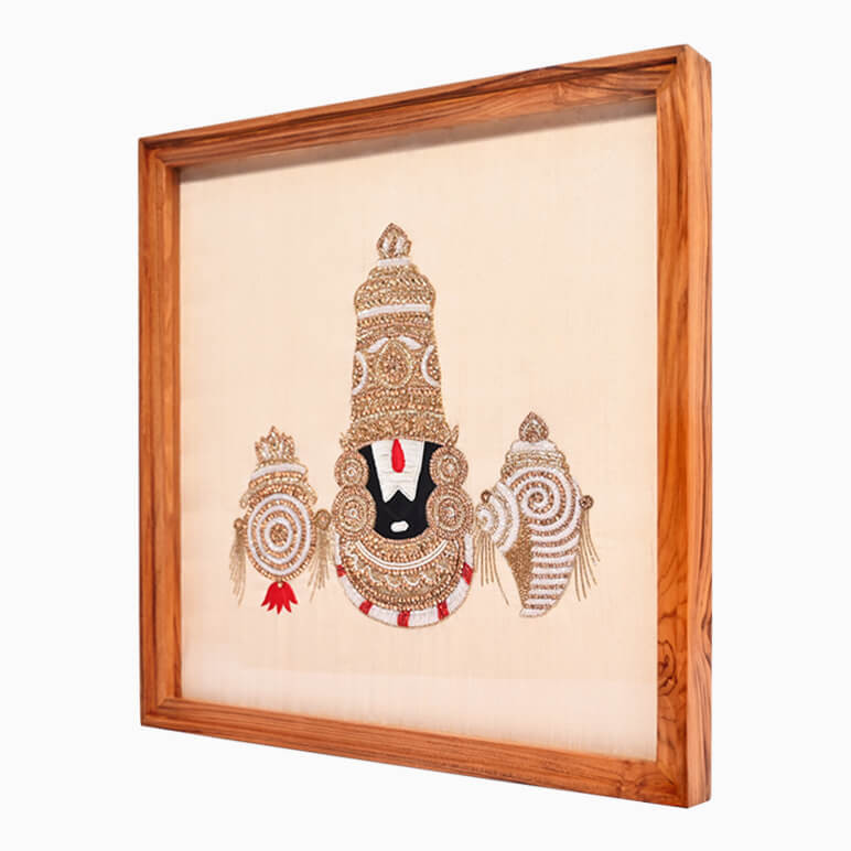 Right angled view of a hand-embroidered textile artwork of Lord Venkateswara, framed in wood