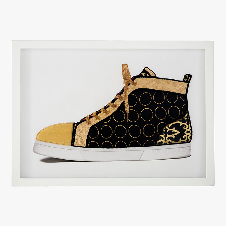 mancave wall decor of a sneaker in black and gold 