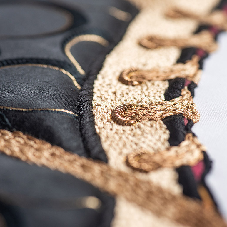 embroidered lace on black and gold sneaker art
