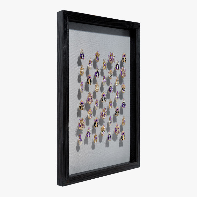 framed 3d wall art with purple beetles seen from the side