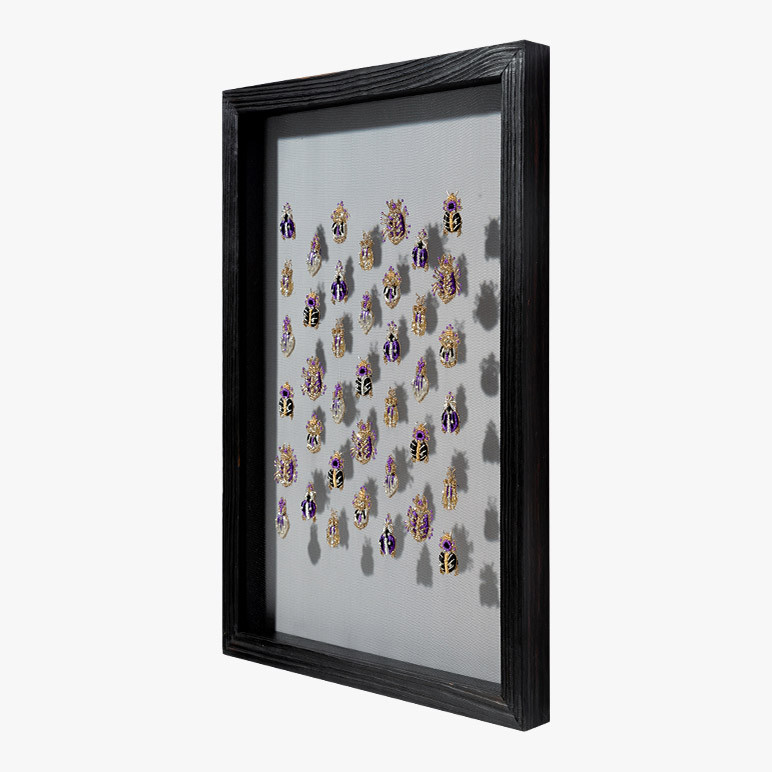 framed 3d wall art with purple beetles seen from side angle