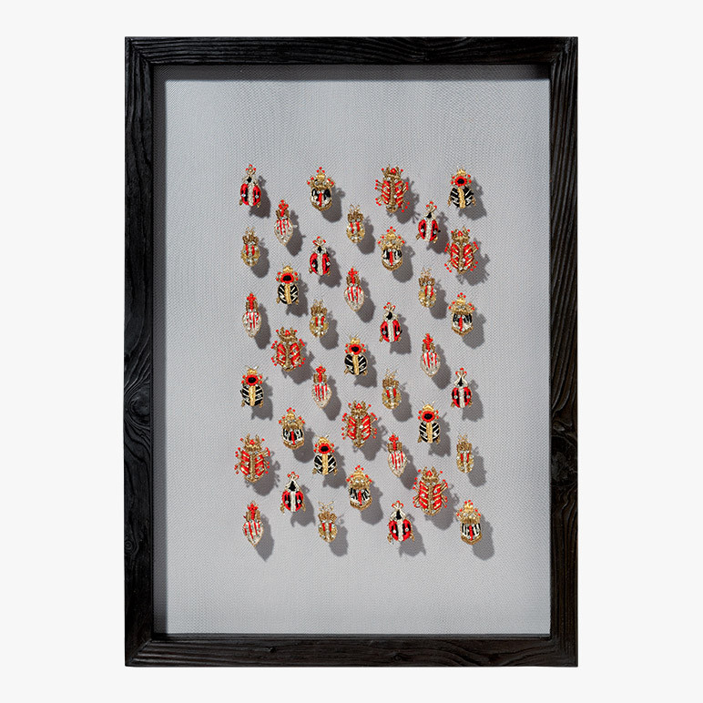 framed wall artwork with metallic beetles embroidered on net fabric