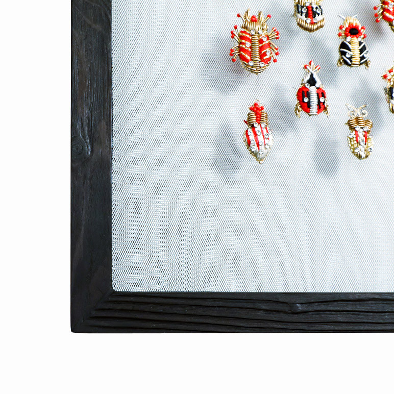 eclectic wall art with embroidered insects