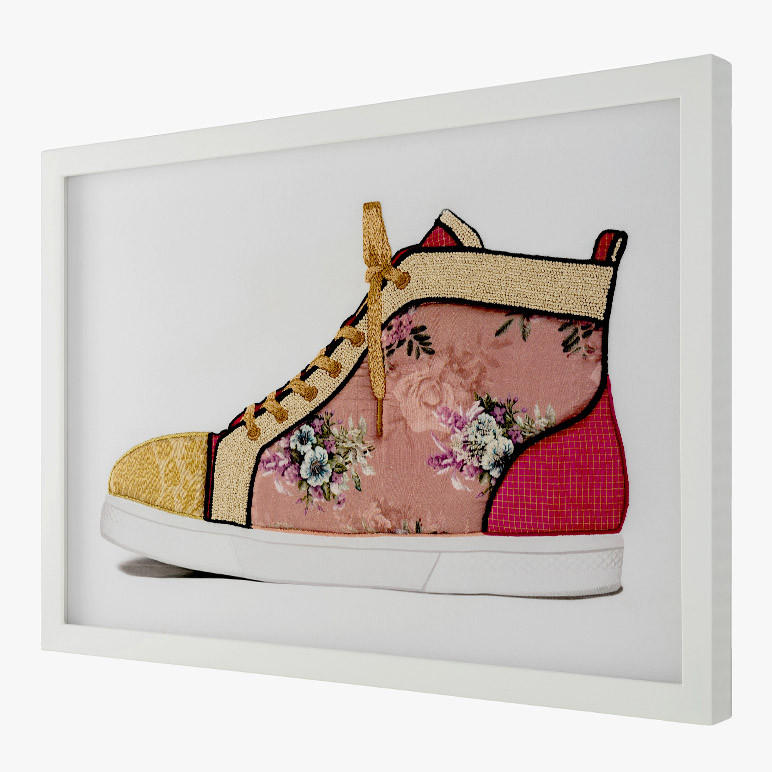 side view of mixed media wall art with a pink floral embroidered sneaker